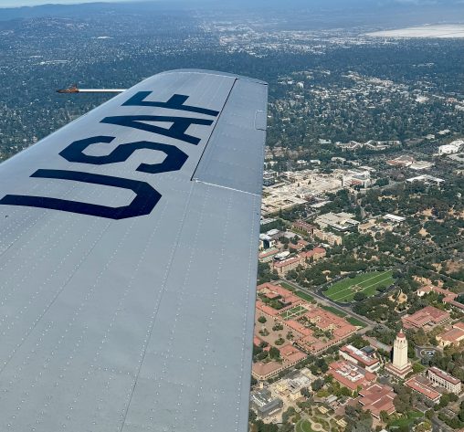View of the wing of a USAF plane, Hoover Tower below