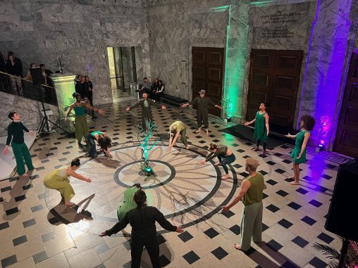 Student dancers dressed in green